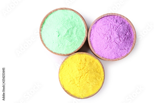 Colorful holi powder in bowls on white background