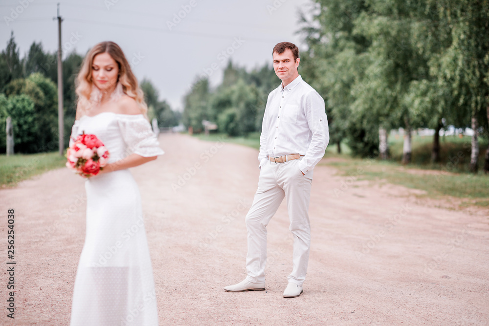 Bride and groom posing on the road