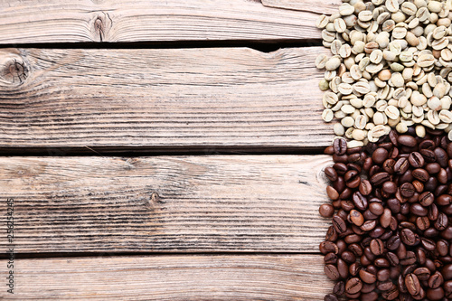 Brown and green coffee beans on wooden table