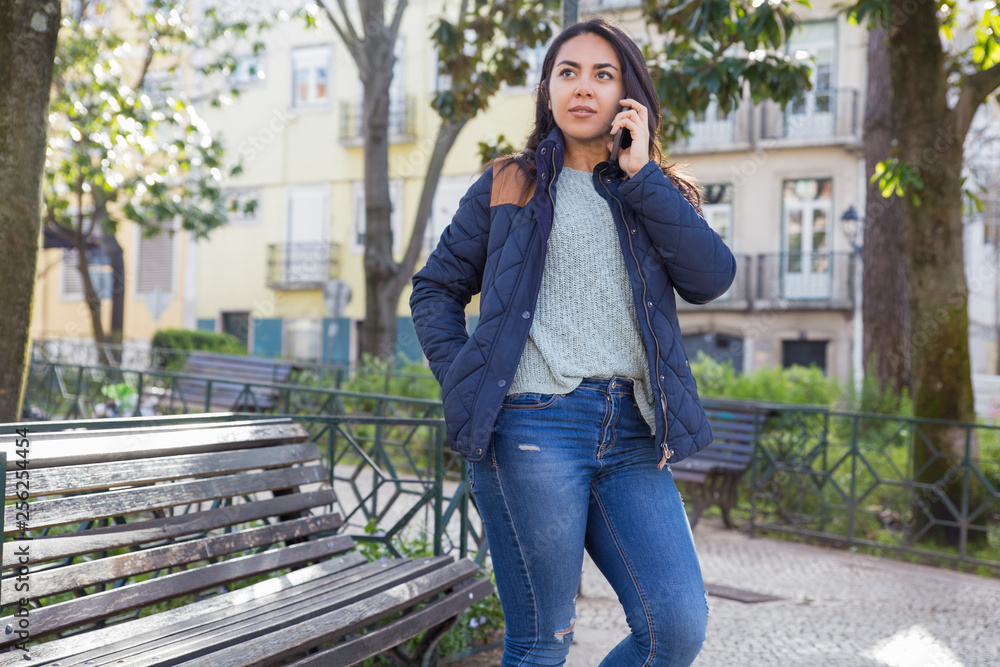 Serious woman calling on mobile phone outdoors Serious woman calling on mobile phone outdoors