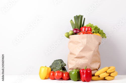 Grocery shopping bag with food on grey background