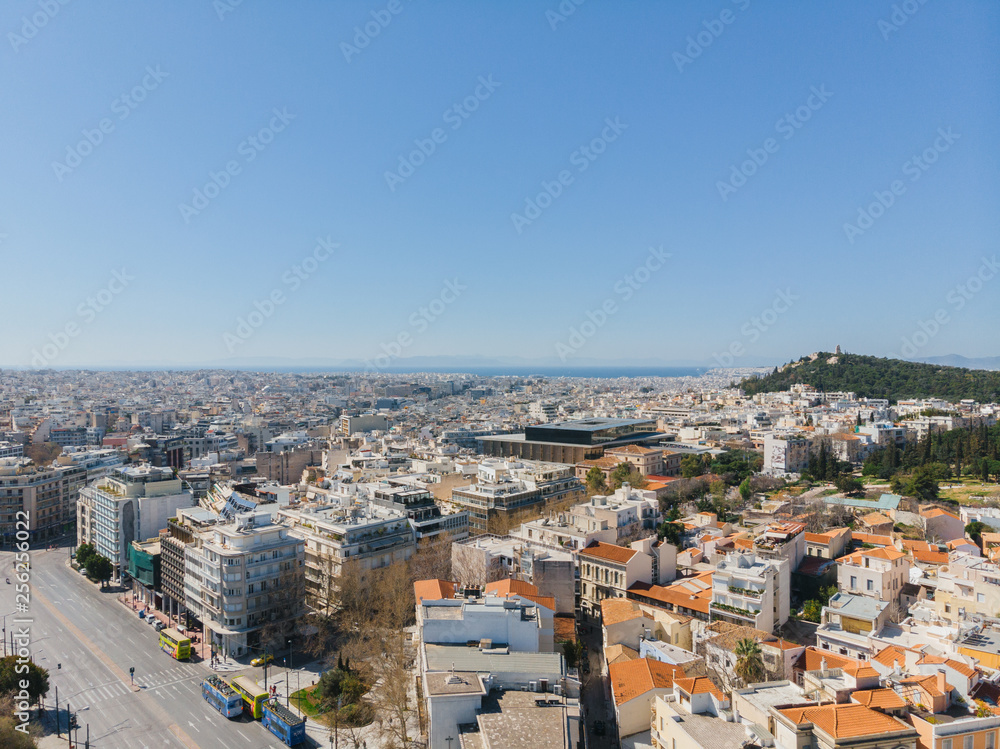 City views of day time with acropolis on a hill at the horizon, Athens, Greece