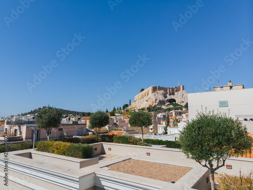 City views of day time with acropolis on a hill at the horizon, Athens, Greece