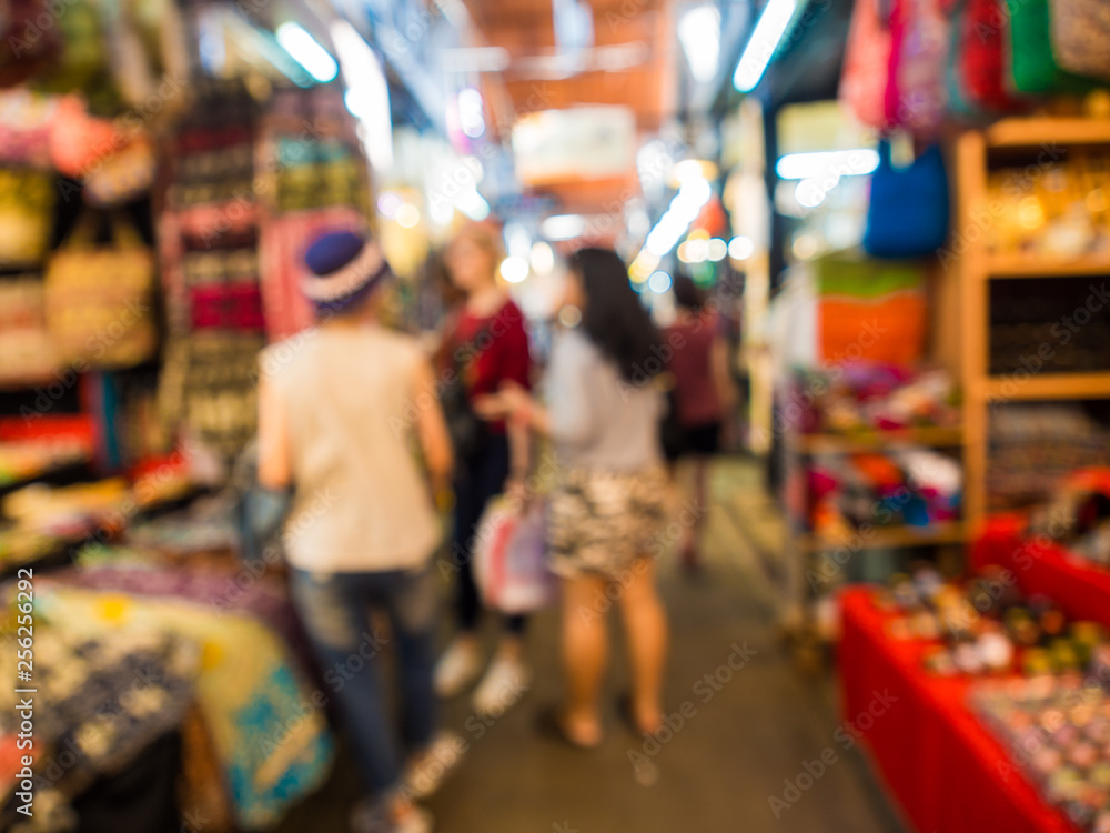 Blurred group of tourist people shopping in souvenir shop