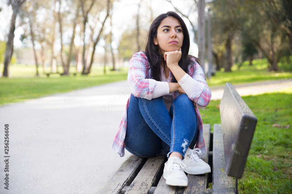 Serious attractive girl thinking about plans in park Serious attractive girl thinking about plans in park
