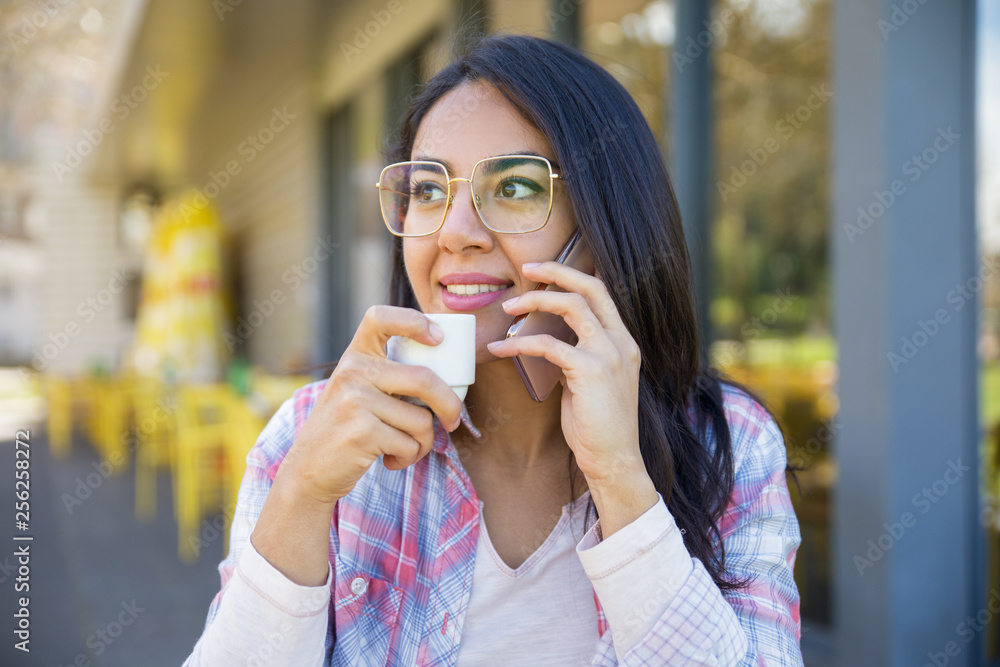 Positive smart student girl resting in street coffee shop Positive smart student girl resting in street coffee shop
