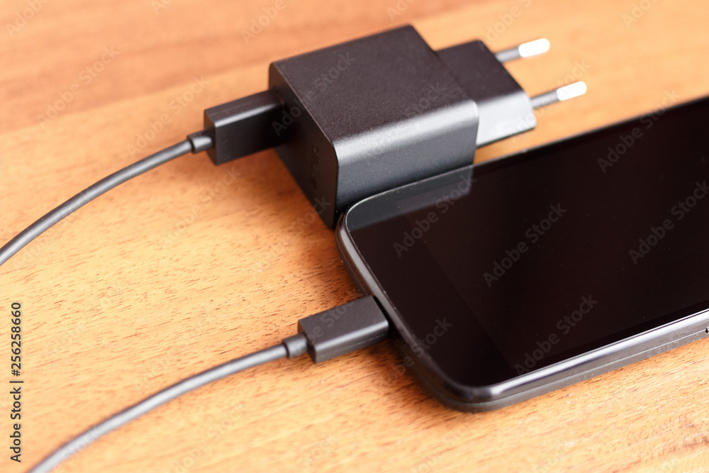 Phone charger usb cable lay on the table Phone charger usb cable lay on the table