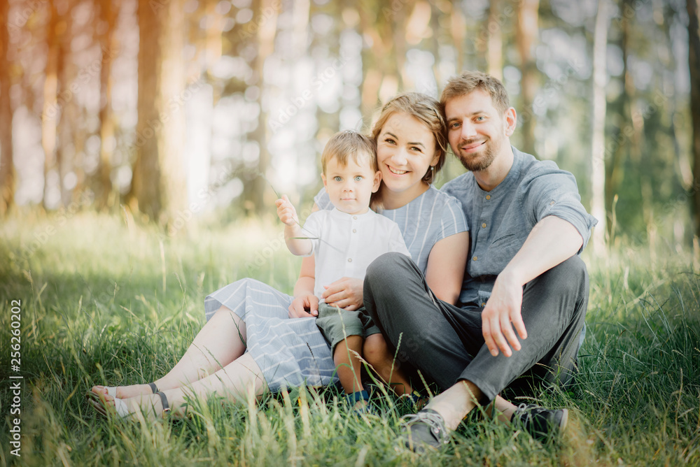 happy parents play with the baby in their arms. Father's mother and their little son are in their arms, family vacation in nature.. happy parents play with the baby in their arms. Father's mother and their little son are in their arms, family vacation in nature..