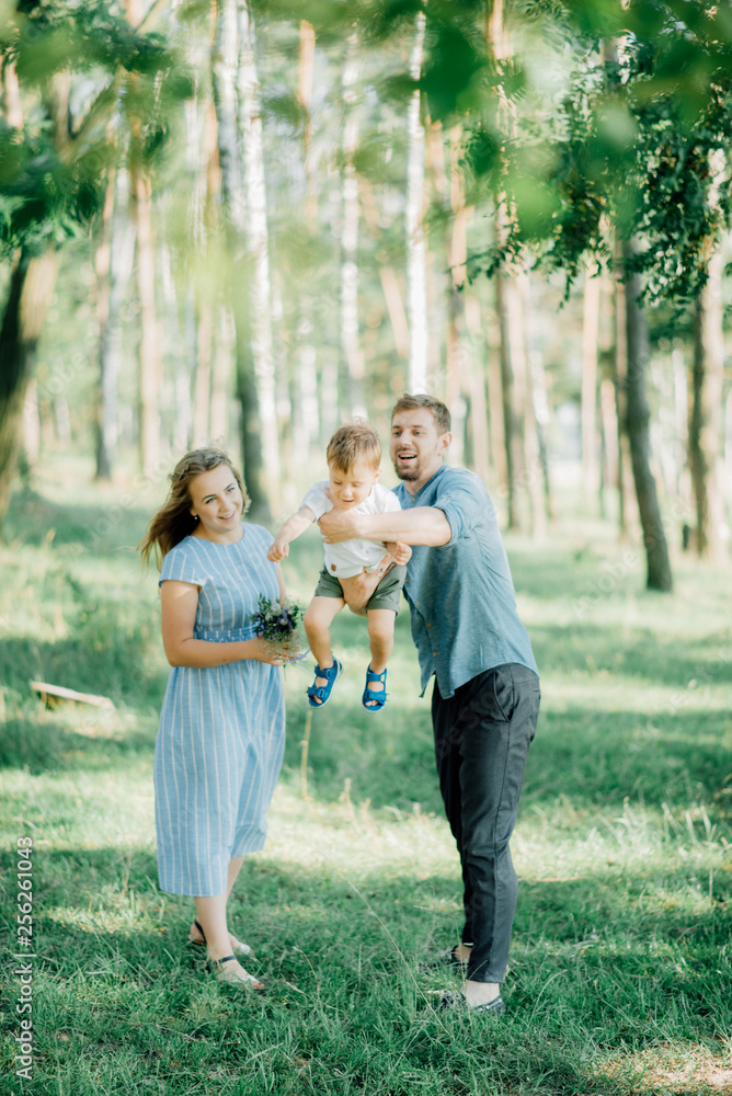 Happy young family spending time together outside in green nature Happy young family spending time together outside in green nature