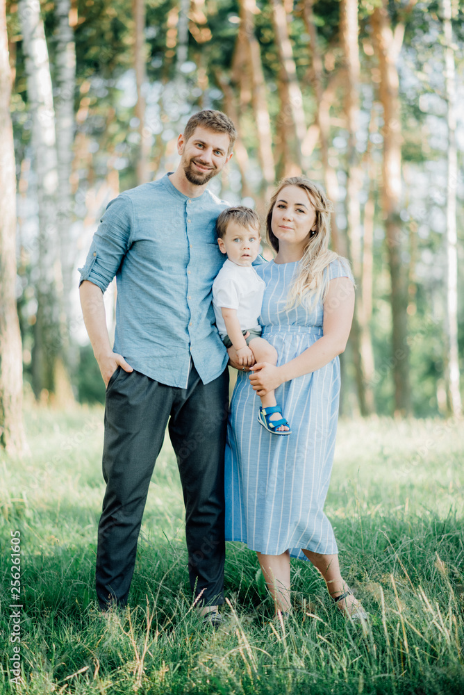 Fototapeta premium Happy young family spending time together outside in green nature