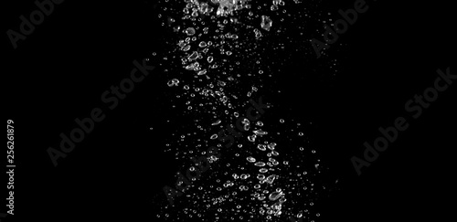 Blurry images of soda liquid water bubbles or carbonate drink or oil shape or beer fizzing or splashing and floating drop in black background for represent sparkling and refreshing photo