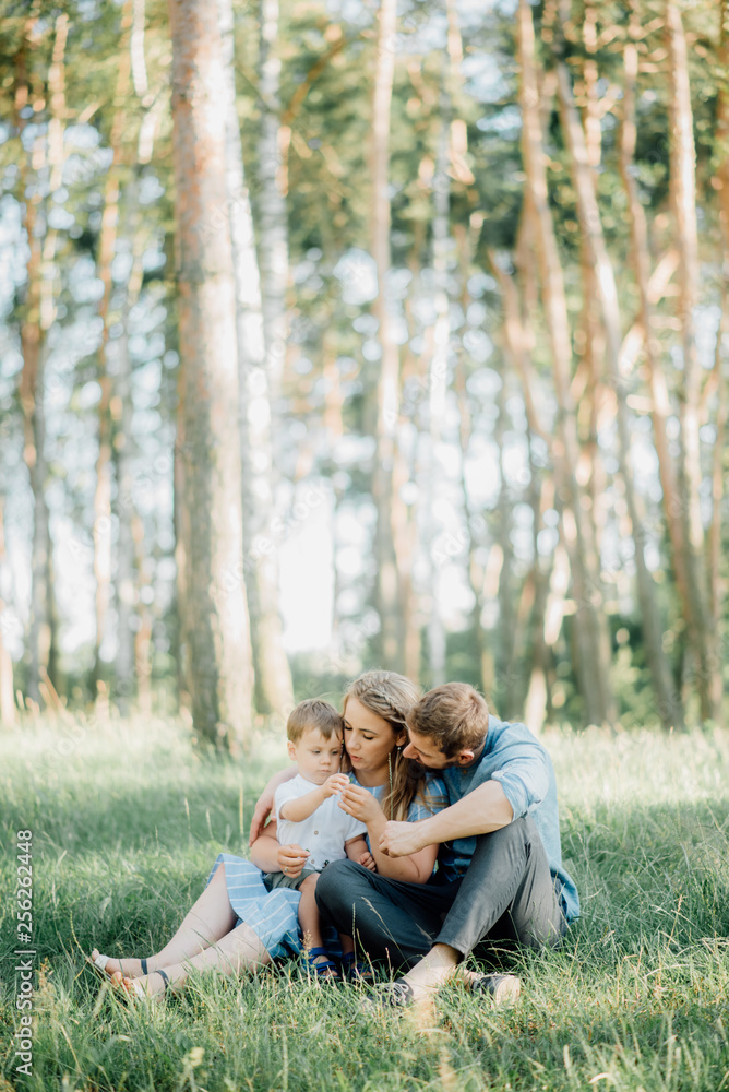 Fototapeta premium Happy young family spending time together outside in green nature