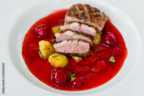 Steak  from fillet of a duck with caramelized strawberry and an eggplant