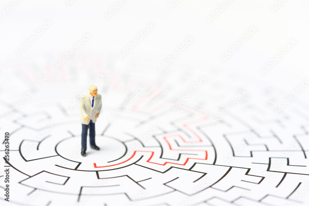 Miniature people, businessman in the labyrinth or maze figuring out the way out. Business concept, finding solution, strategic, and business opportunity. Miniature people, businessman in the labyrinth or maze figuring out the way out. Business concept, finding solution, strategic, and business opportunity.