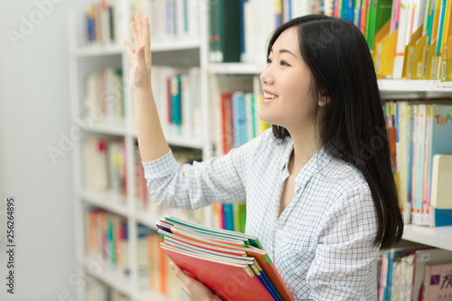 Young Asian female student at the library