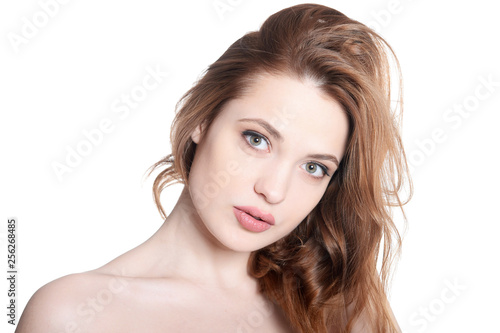 Close up portrait of beautiful young woman with perfect skin on white background