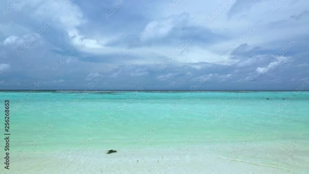 Gorgeous view of Indian Ocean, Maldives. White sand coast line, turquoise ocean water and blue sky with white clouds. Gorgeous nature landscape background. Gorgeous view of Indian Ocean, Maldives. White sand coast line, turquoise ocean water and blue sky with white clouds. Gorgeous nature landscape background.