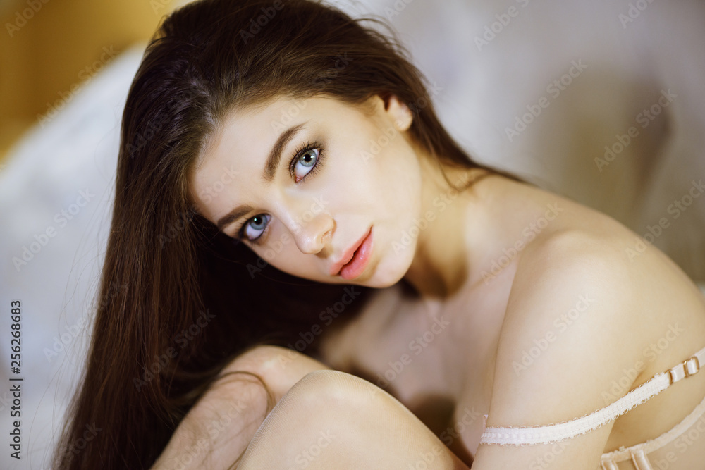 Naklejka premium Fashionable female portrait of cute lady in white bra indoors
