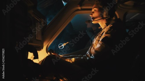 Portrait of woman flying helicopter at night