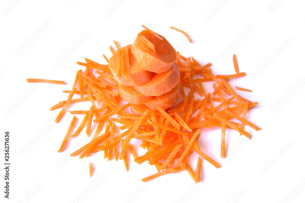 Tower of carrot circles sprinkled with straws on white background