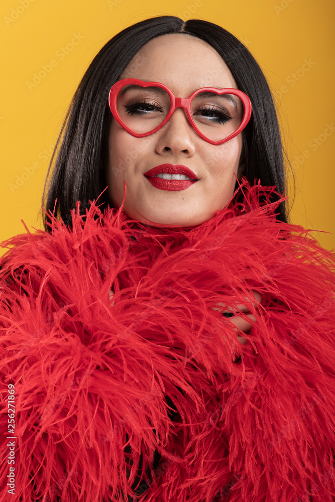 Beautiful Asian woman with vibrant red feather boa and heart shaped