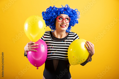 Happy woman with blue hair holding colorful balloons  © Mat Hayward