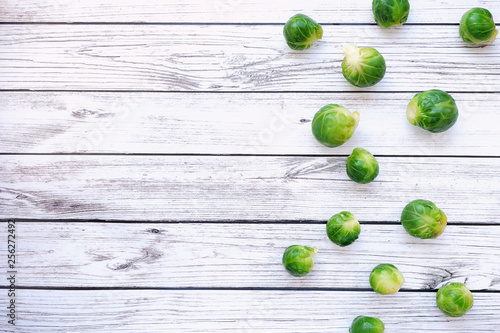 Brussels sprouts on a wooden background, empty space for text