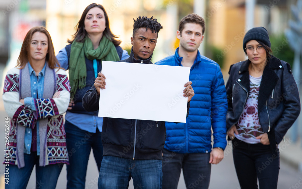 Group of protesters holding a blank sign during demonstration - obrazy, fototapety, plakaty 