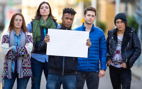 Group of protesters holding a blank sign during demonstration © Mat Hayward