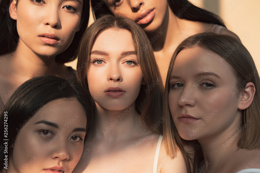 five beautiful multicultural girls looking at camera in sunlight five beautiful multicultural girls looking at camera in sunlight