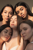 five dreamy multicultural girls posing at camera in sunlight