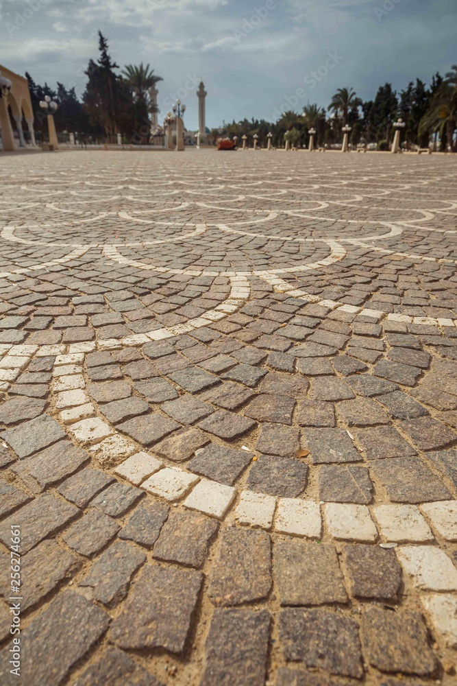 Fototapeta premium Cobbles on the square close-up. View in front of the mausoleum of Habib Bourguiba, Monastir, Tunisia, North Africa