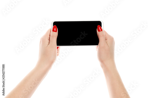 Hands of a young girl holding a smartphone isolated on white background. Perfect manicure.