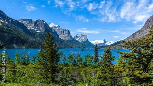 Spring at Saint Mary Lake - Time-lapse video of a panoramic view of high clouds passing over blue Saint Mary Lake and its surrounding steep mountains in Glacier National Park, Montana, USA. photo