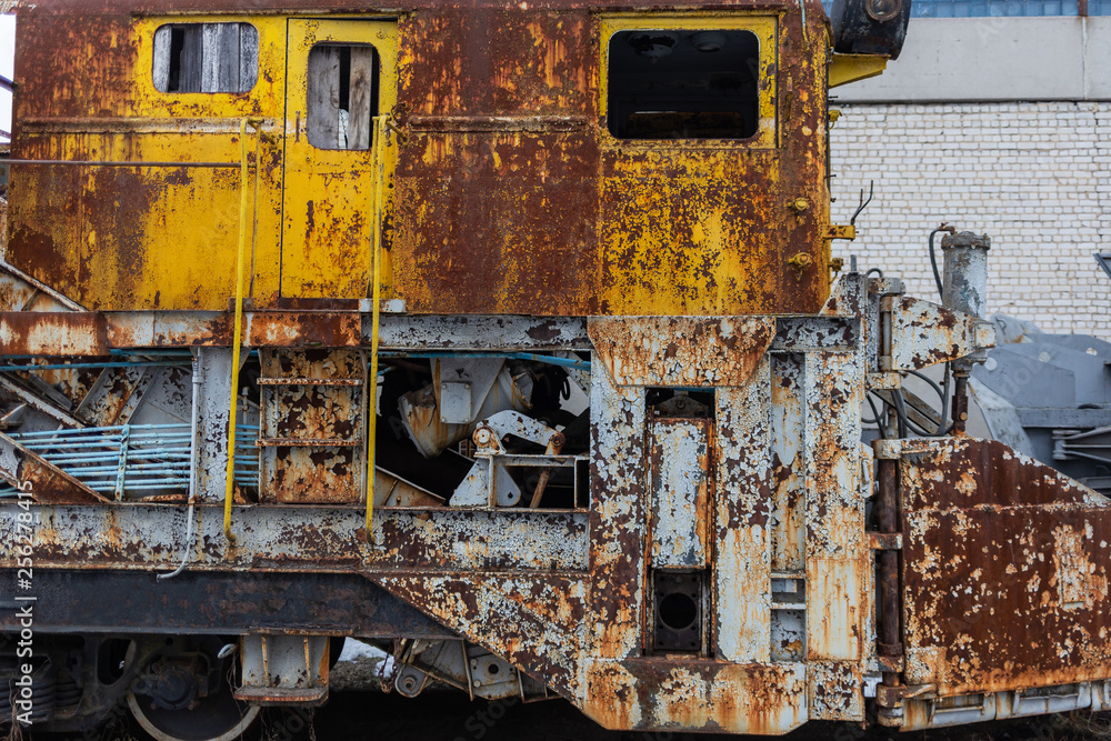 Rusty old weathered train standing outdoors. Horizontal color photography.