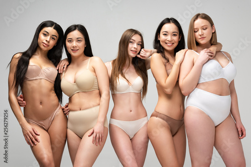 Five young multiethnic women in underwear posing at camera isolated on grey, body positivity concept