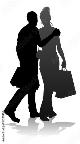 People silhouette of a young man and woman, probably a couple or husband and wife shopping holding retail bags