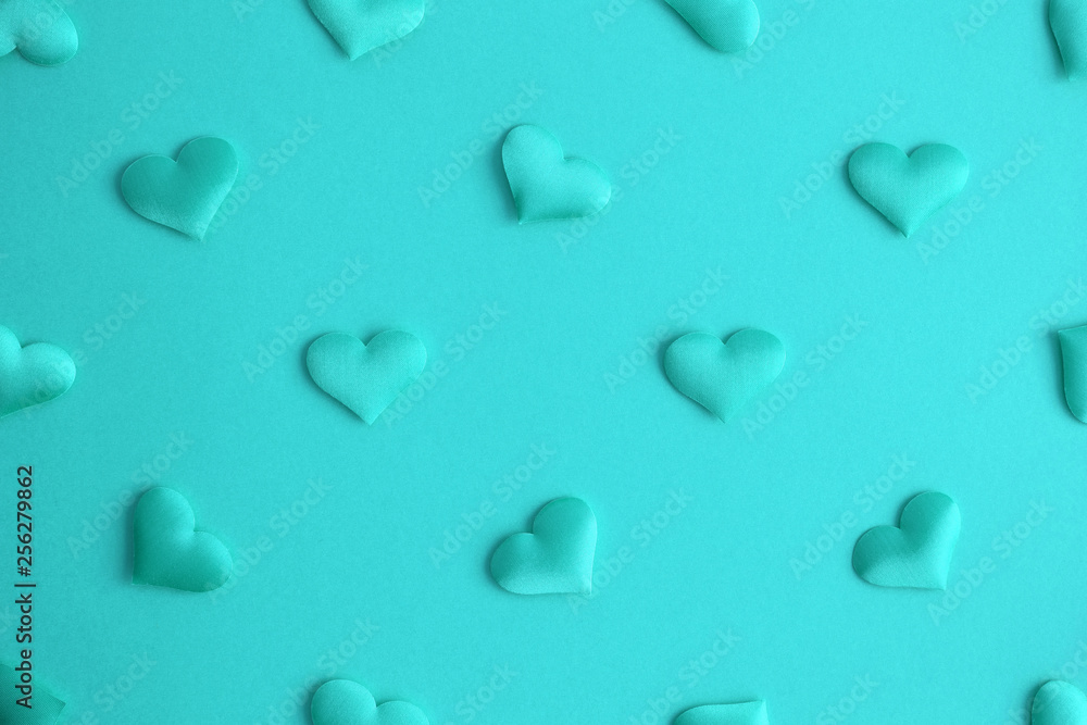 Flat lay of hearts decoration on turquoise background abstract.