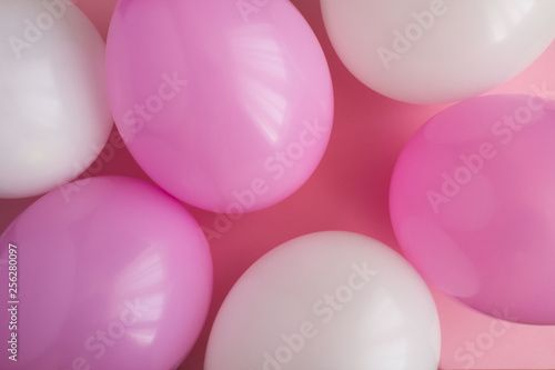 Pink and white balloons on the pink background.Top view.Copy space.
