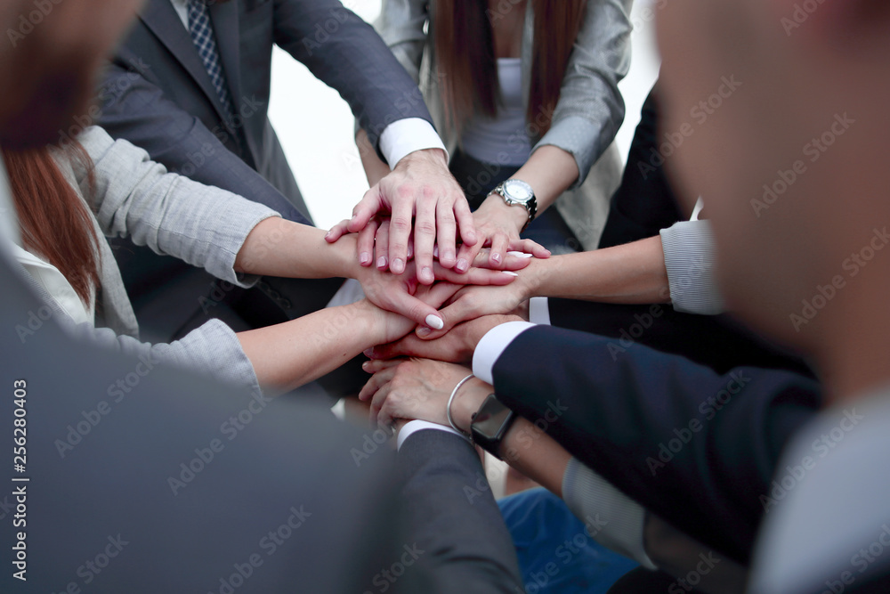 Close-Up of hands business team showing unity with putting their hands together.