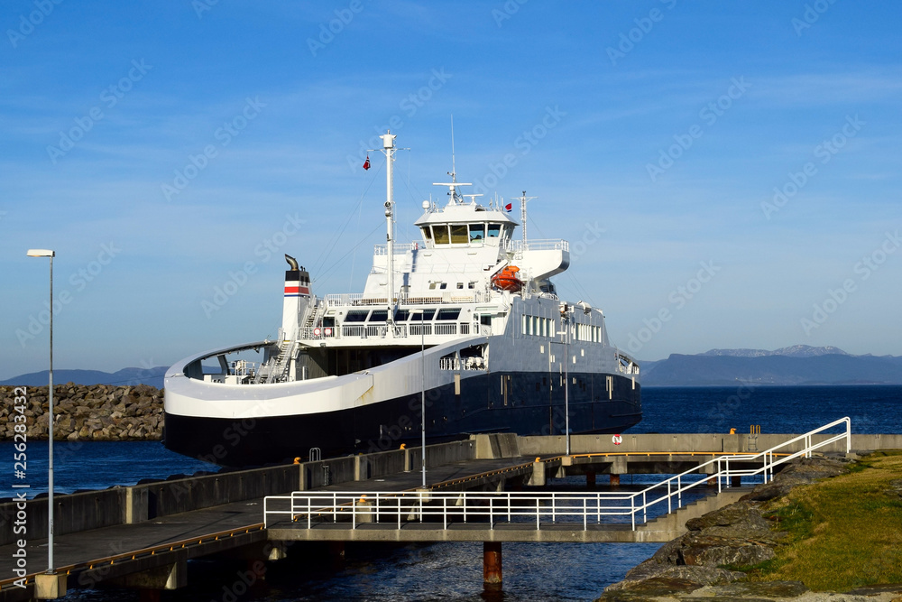 Naklejka premium Ferry against the blue sea and sky near the port. Sea transport. Norway