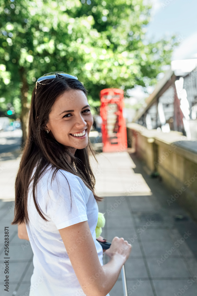 UK, London, portrait of smiling young woman on the street UK, London, portrait of smiling young woman on the street