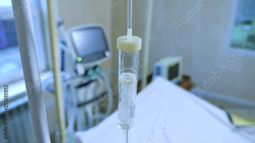 Medical equipment. Perfusion serum. Close up saline IV drip for patient and Infusion pump in hospital. Medical drop counter. Macro shot. Apparatus and valve control for saline solution to patient