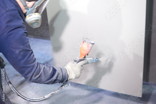 A man produces powder paint metal products.