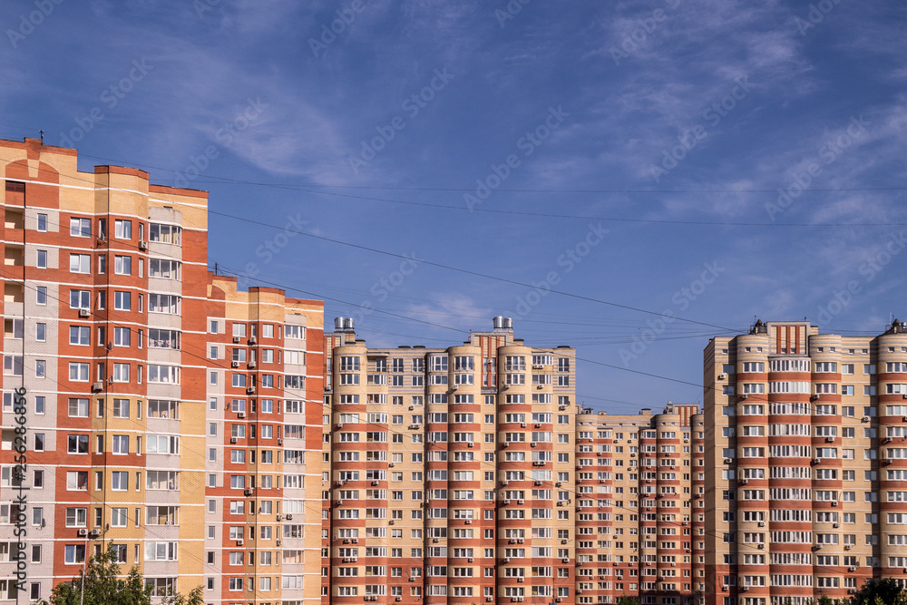 The new multi-storey residential buildings with blue sky background. Apartment purchase concept
