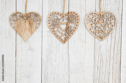 Wood hearts on weathered whitewash textured wood background