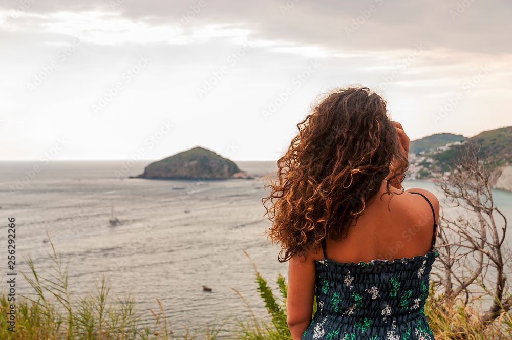 closeup of beautiful girl posing with panoramic view of Ischia closeup of beautiful girl posing with panoramic view of Ischia