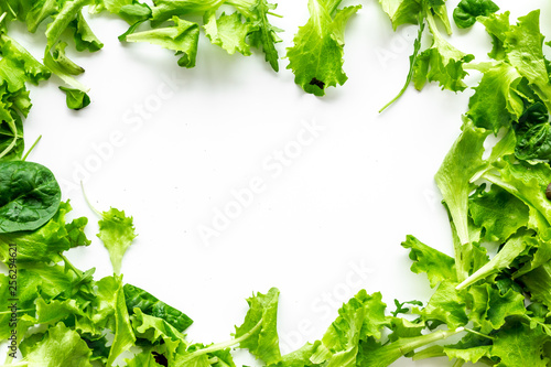 fitness food cooking with green salad mix on white background top view copyspace