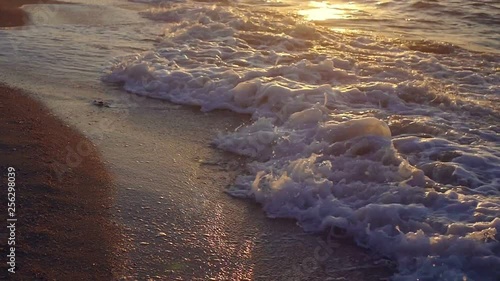 Sea waves at sunset closeup