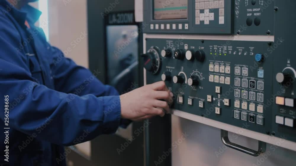 Macro control unit CNC machines and workers finger sets the program command Macro control unit CNC machines and workers finger sets the program command
